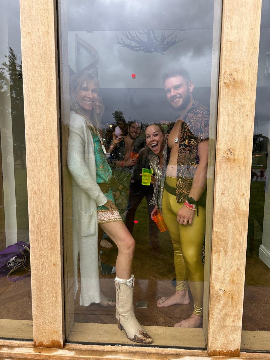 Friends in festival dress at the house window