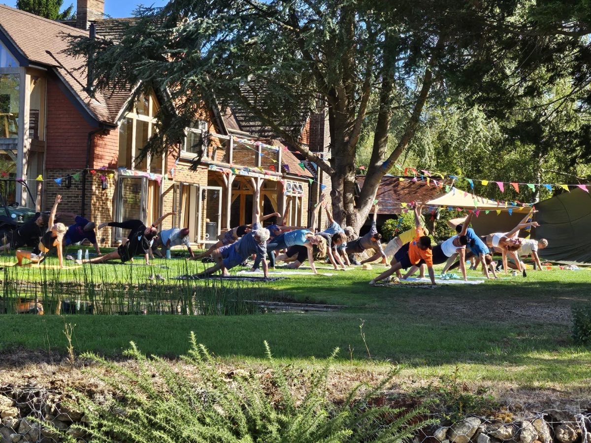 A yoga class on the lawn in front of the house