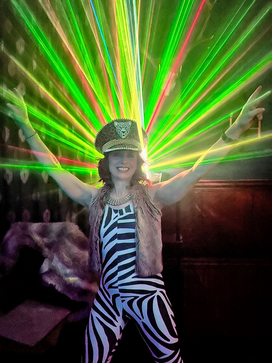 Dancing in zebra print under green lasers