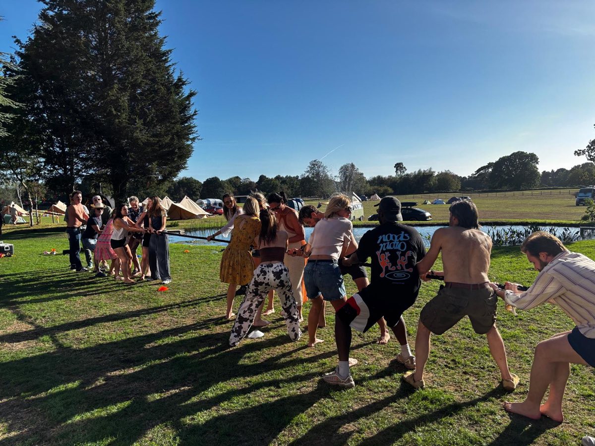 A tug of war on the lawn by the pond