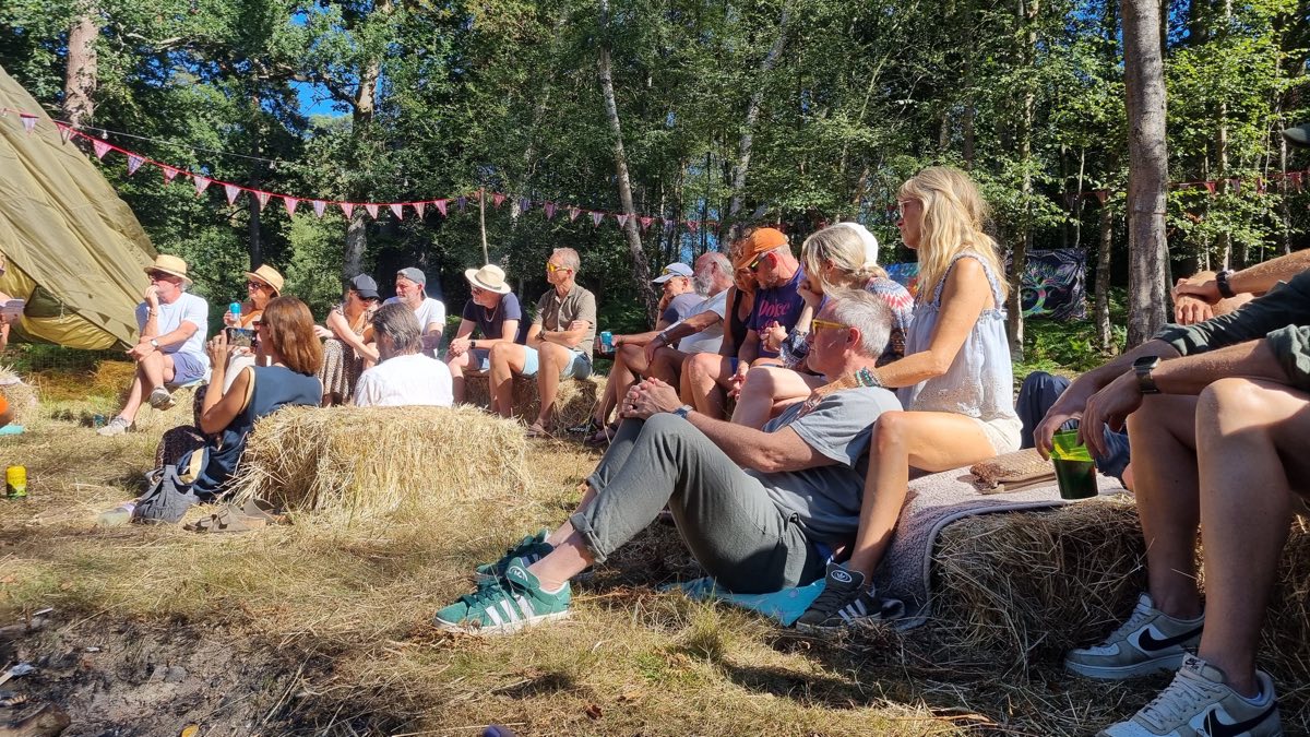 Everyone on hay bales for a talk in the woods