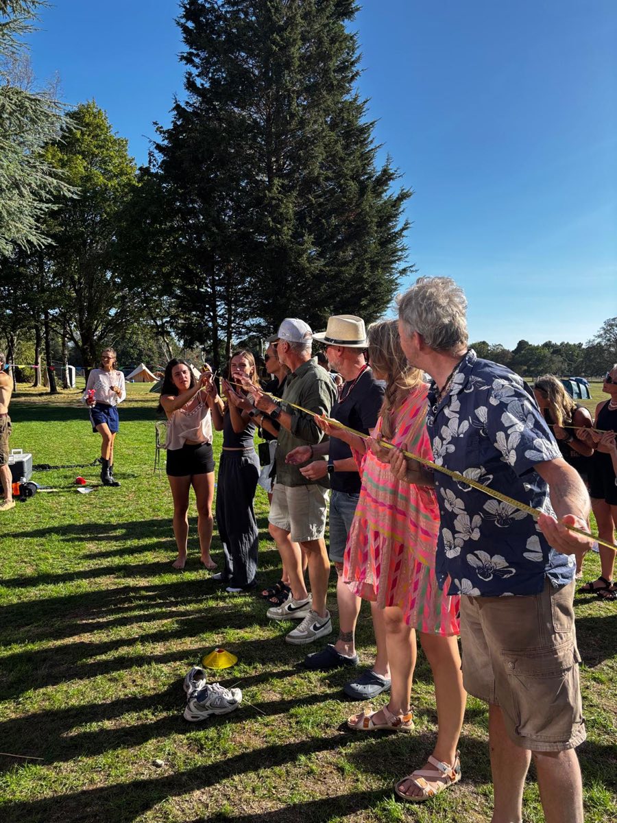 Tug of war in the sunshine, everyone hauling on the rope
